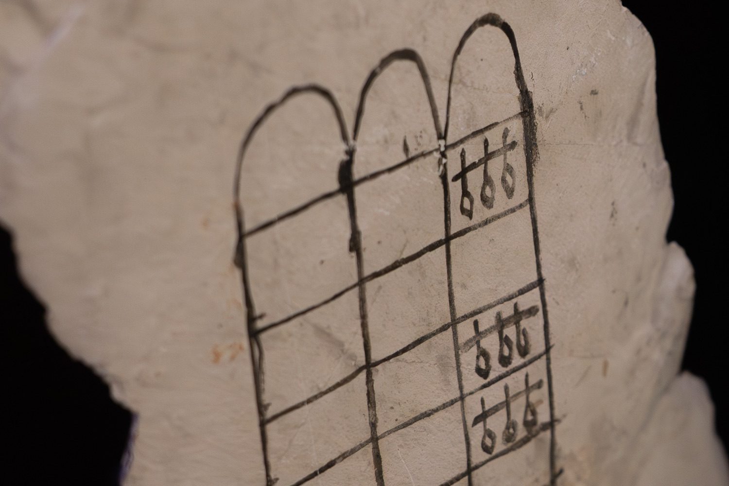 Detail of the senet board on the ostracon: the squares of the grid and the hieroglyphs marking the special houses.